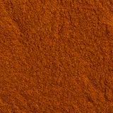 Close-up image of a reddish-brown, finely ground spice, identified as Organic Cinnamon Refill by Evermill, covering the entire frame with a slightly uneven texture. The surface exhibits small grains and a rich, vibrant color perfect for enhancing savory and sweet dishes.
